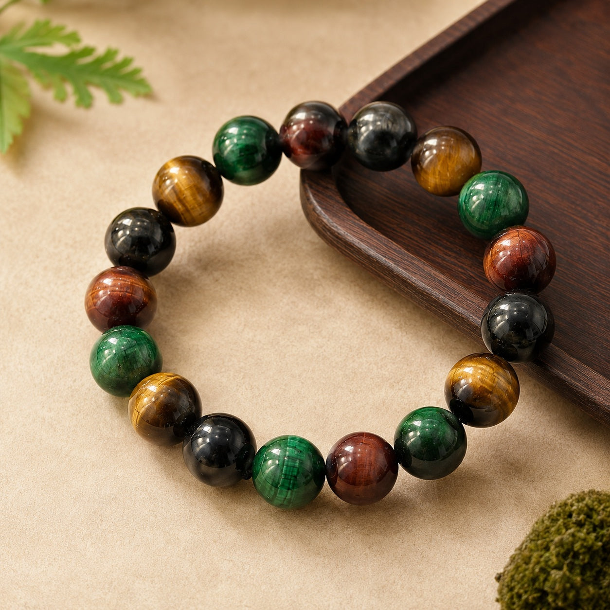 Round four-color tiger’s eye beaded bracelet on a beige stone surface