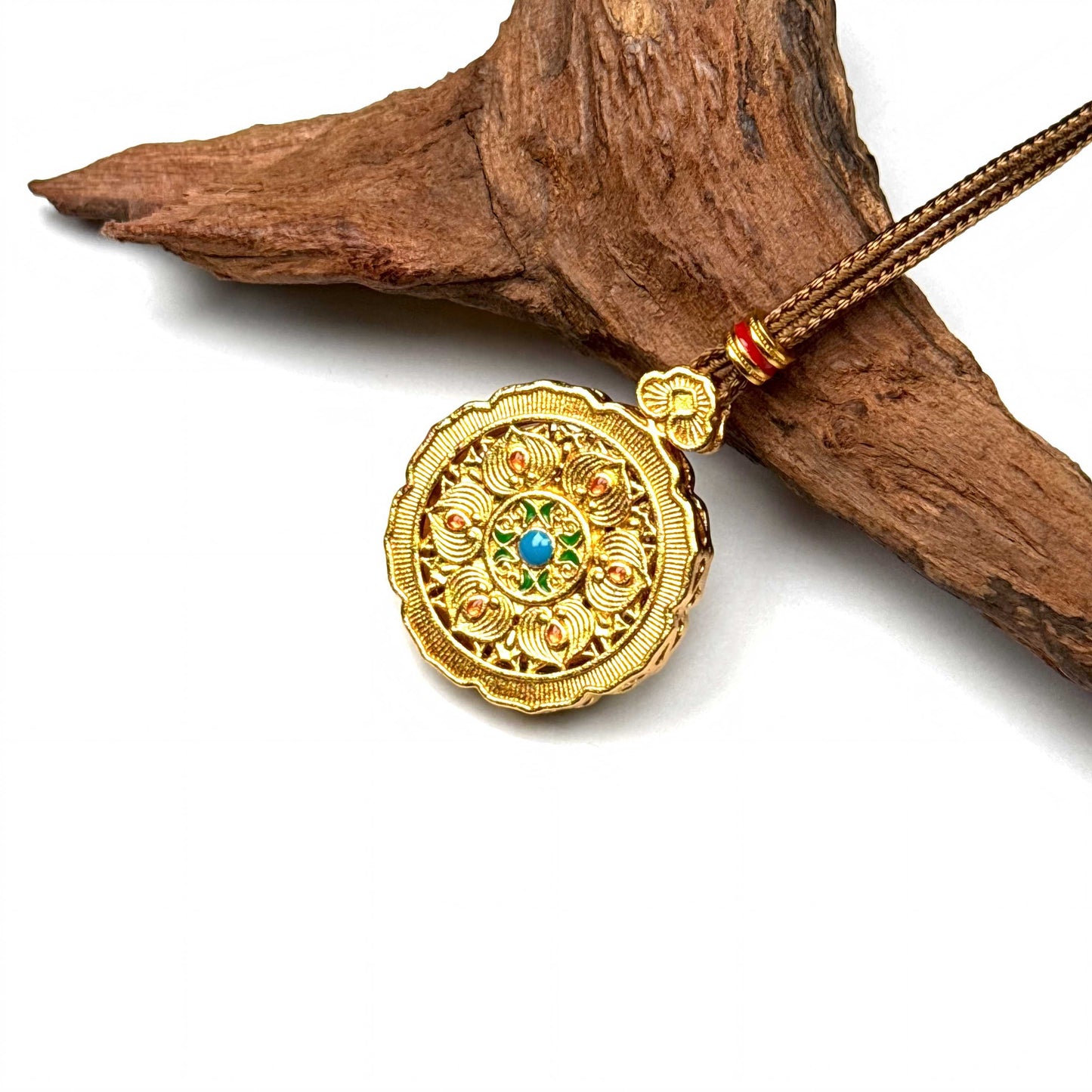Macro shot of a reversible sand gold and enamel spinner pendant mid-turn, showcasing exquisite craftsmanship and rhinestones.