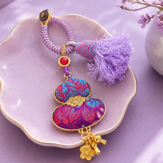 Purple brocade lucky gourd hanging charm with soft cotton tassel and gold-tone accents