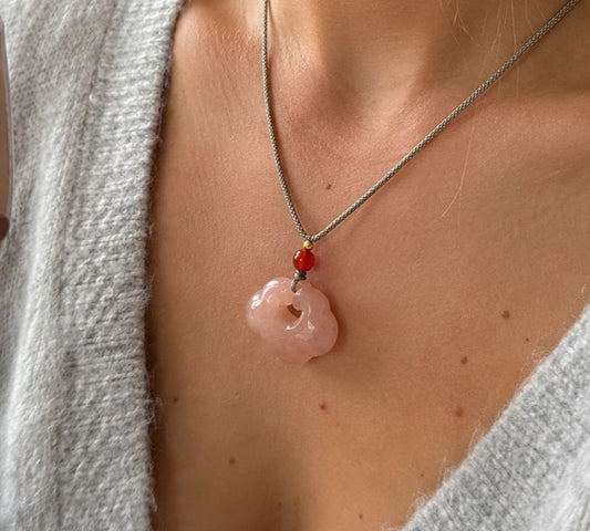 Woman wearing a pink quartzite jade auspicious cloud pendant necklace