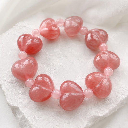 Close-up of a pink quartzite jade heart bead bracelet