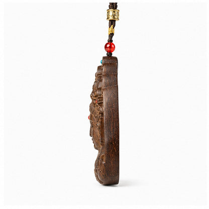 Side view showing the one-centimeter thickness of an agarwood Guanyin pendant