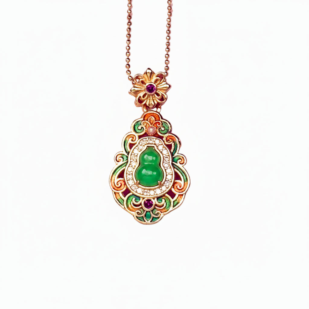 A crisp front view of an authentic sand gold Hulu gourd pendant featuring a central translucent green chalcedony stone, colorful enamel leaf motifs, and a brilliant rhinestone border on a white background.