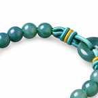 Blue Green Ring Bead Bracelet - cord and bead detail on white