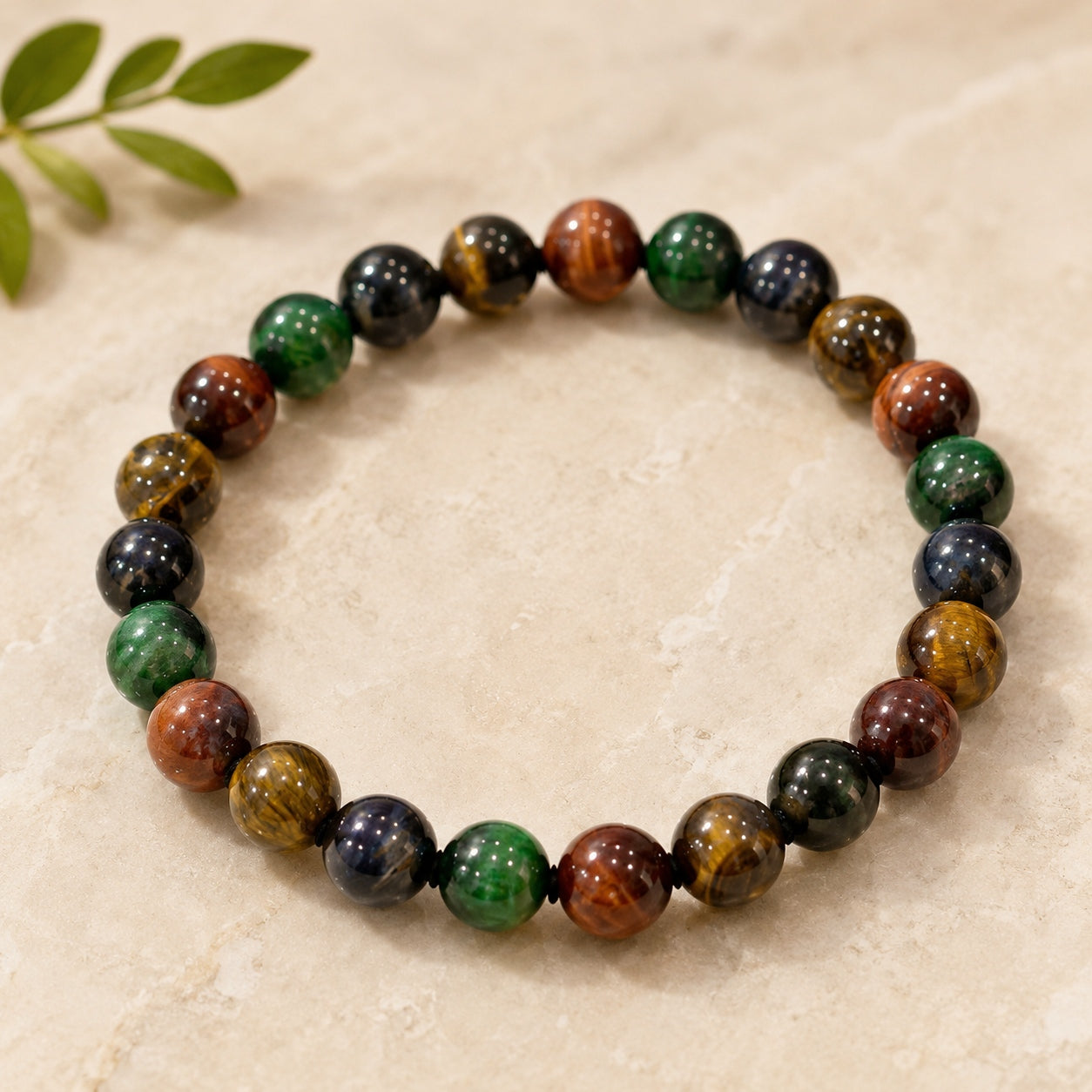 Four-color tiger’s eye beaded bracelet displayed against a ceramic vase