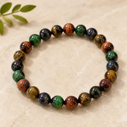 Four-color tiger’s eye beaded bracelet displayed against a ceramic vase