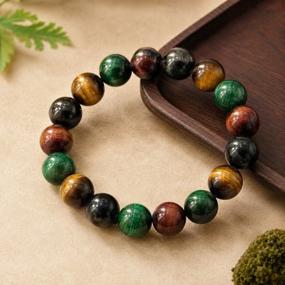 Round four-color tiger’s eye beaded bracelet on a beige stone surface
