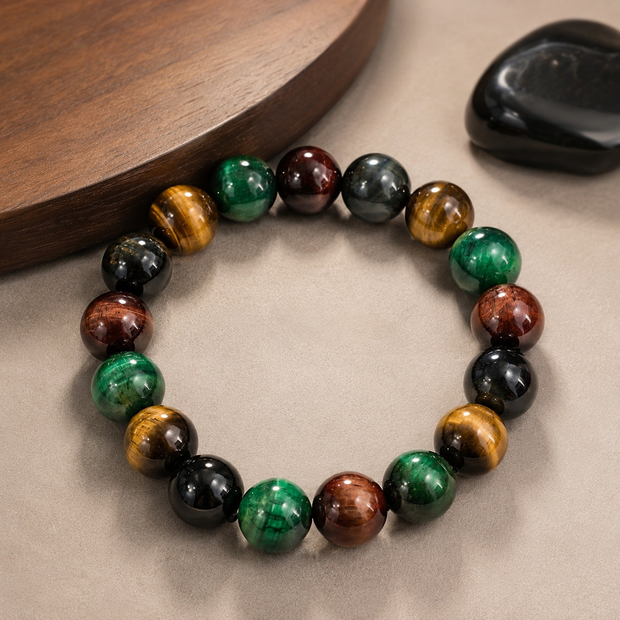 Four-color tiger’s eye bead bracelet displayed beside a wooden tray