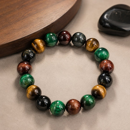 Four-color tiger’s eye bead bracelet displayed beside a wooden tray