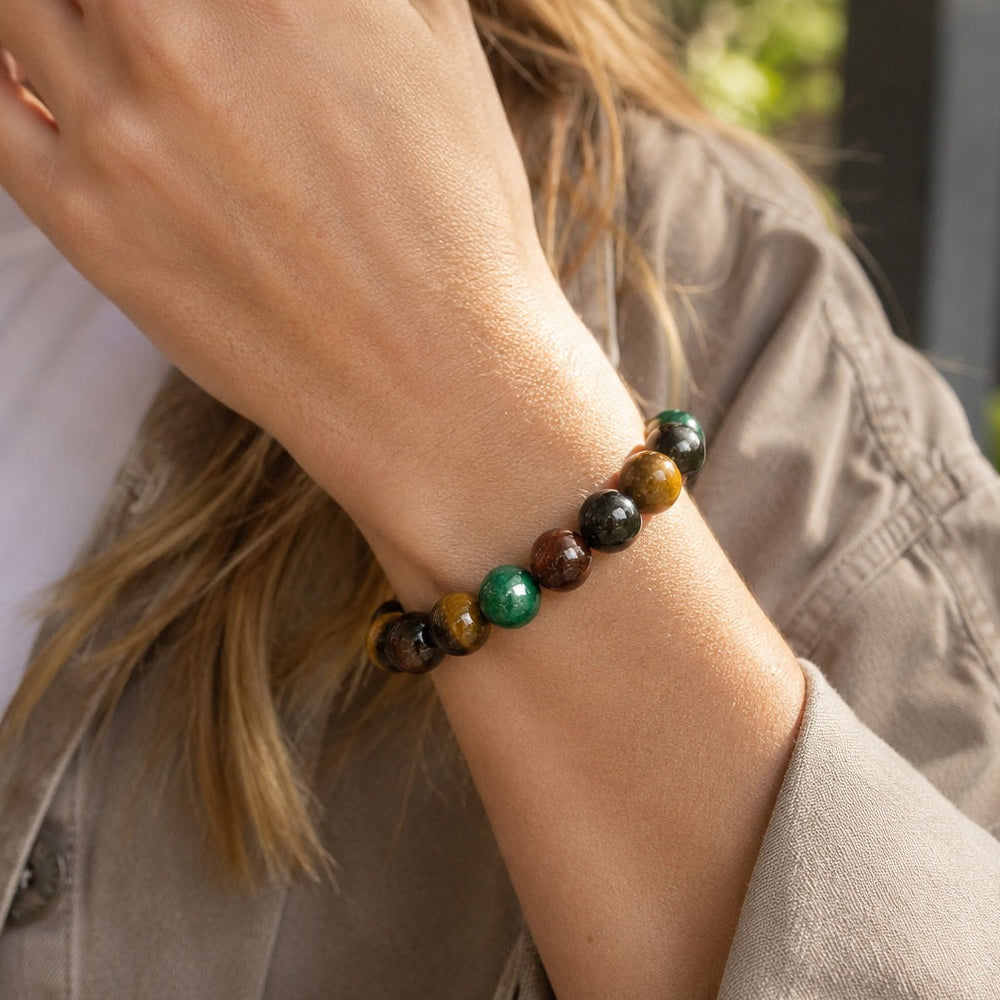 Woman wearing a four-color tiger’s eye beaded bracelet outdoors