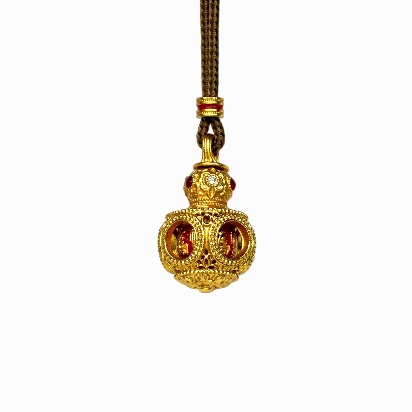 The detailed side-front view of a gold filigree Hulu gourd amulet, highlighting the circular cut-out windows and intricate hollow latticework.
