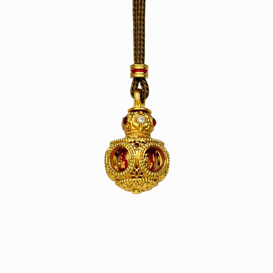 The detailed side-front view of a gold filigree Hulu gourd amulet, highlighting the circular cut-out windows and intricate hollow latticework.