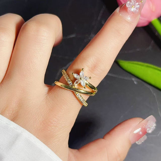 Gold-plated 925 sterling silver floral cross adjustable ring worn on a finger