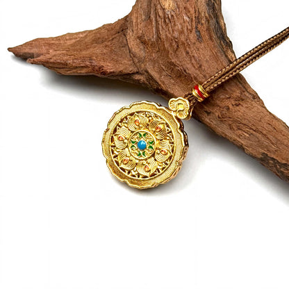 Macro shot of a reversible sand gold and enamel spinner pendant mid-turn, showcasing exquisite craftsmanship and rhinestones.