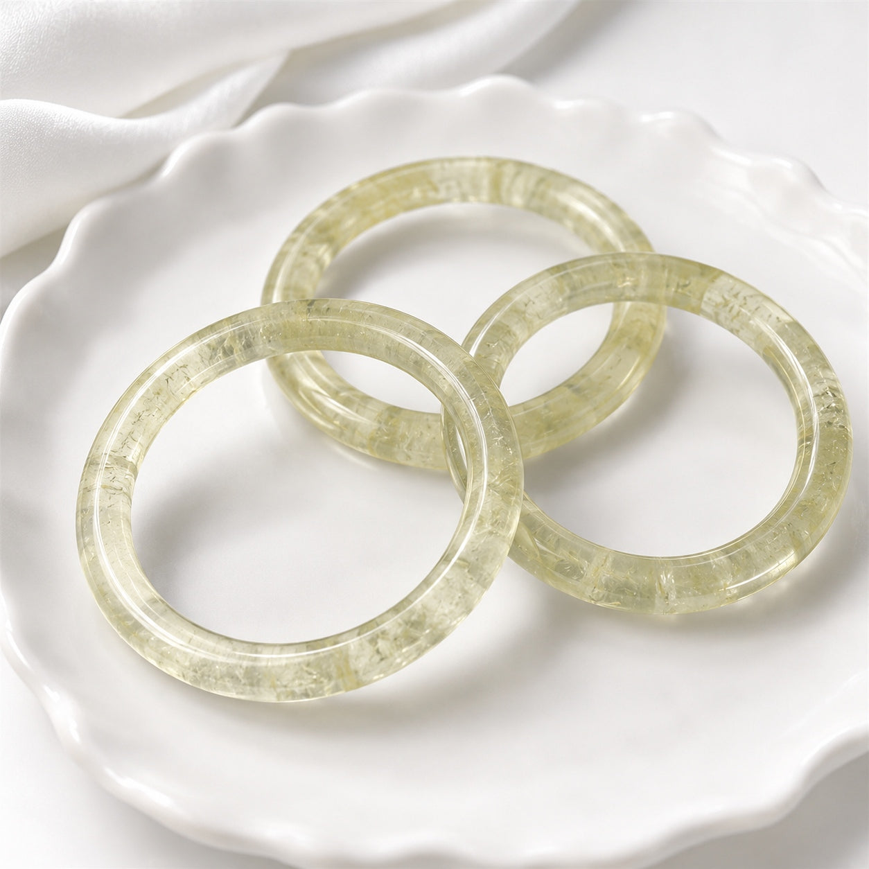 bangle-set.webp
Translucent yellow citrine bangles displayed on a white ceramic tray