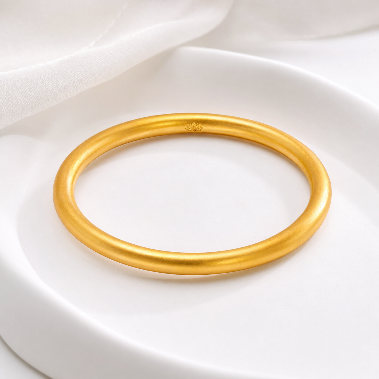 Golden lotus sandgold bangle displayed on white tray