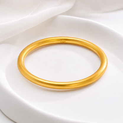 Golden lotus sandgold bangle displayed on white tray