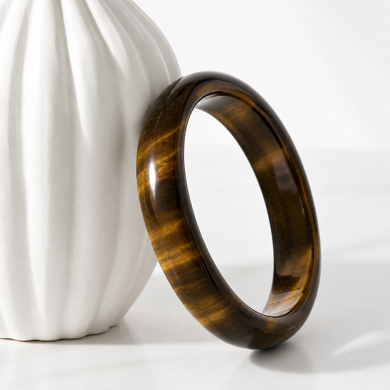 Polished tiger’s eye bangle bracelet with golden-brown sheen