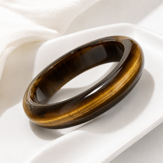 Tiger’s eye bangle bracelet displayed on a white jewelry tray