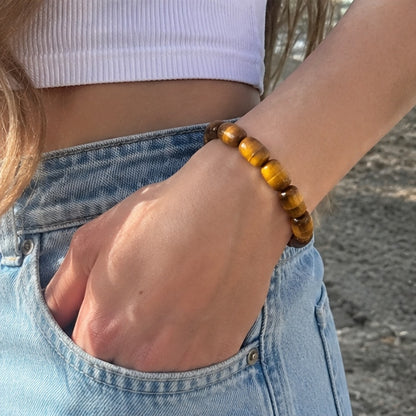 Close-up of a golden tiger’s eye barrel bead bracelet worn on the wrist
