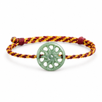 Green Sun Disc Cord Bracelet - angled view on white