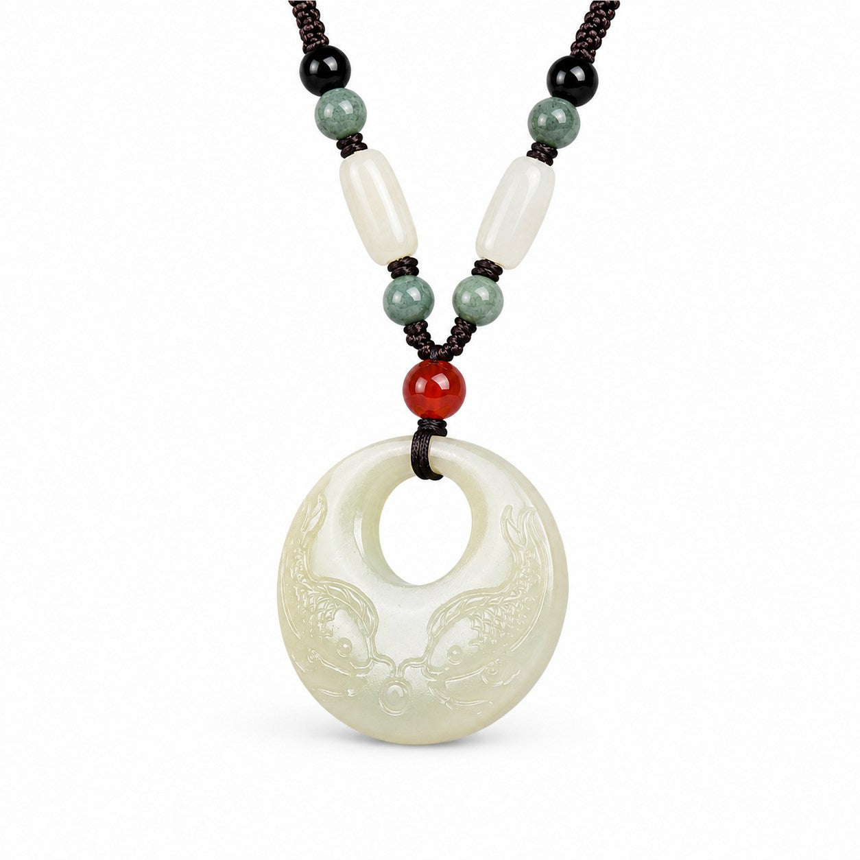 Close view of a carved Hetian jade double fish pendant with circular opening