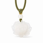 Detail view of carved white Hetian jade lotus pendant with white jade bead