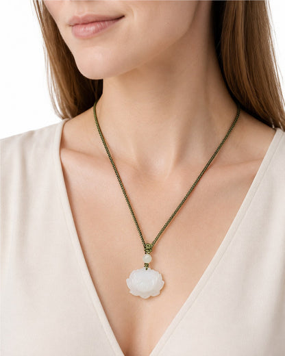 Woman wearing a white Hetian jade lotus pendant necklace with olive-green braided cord
