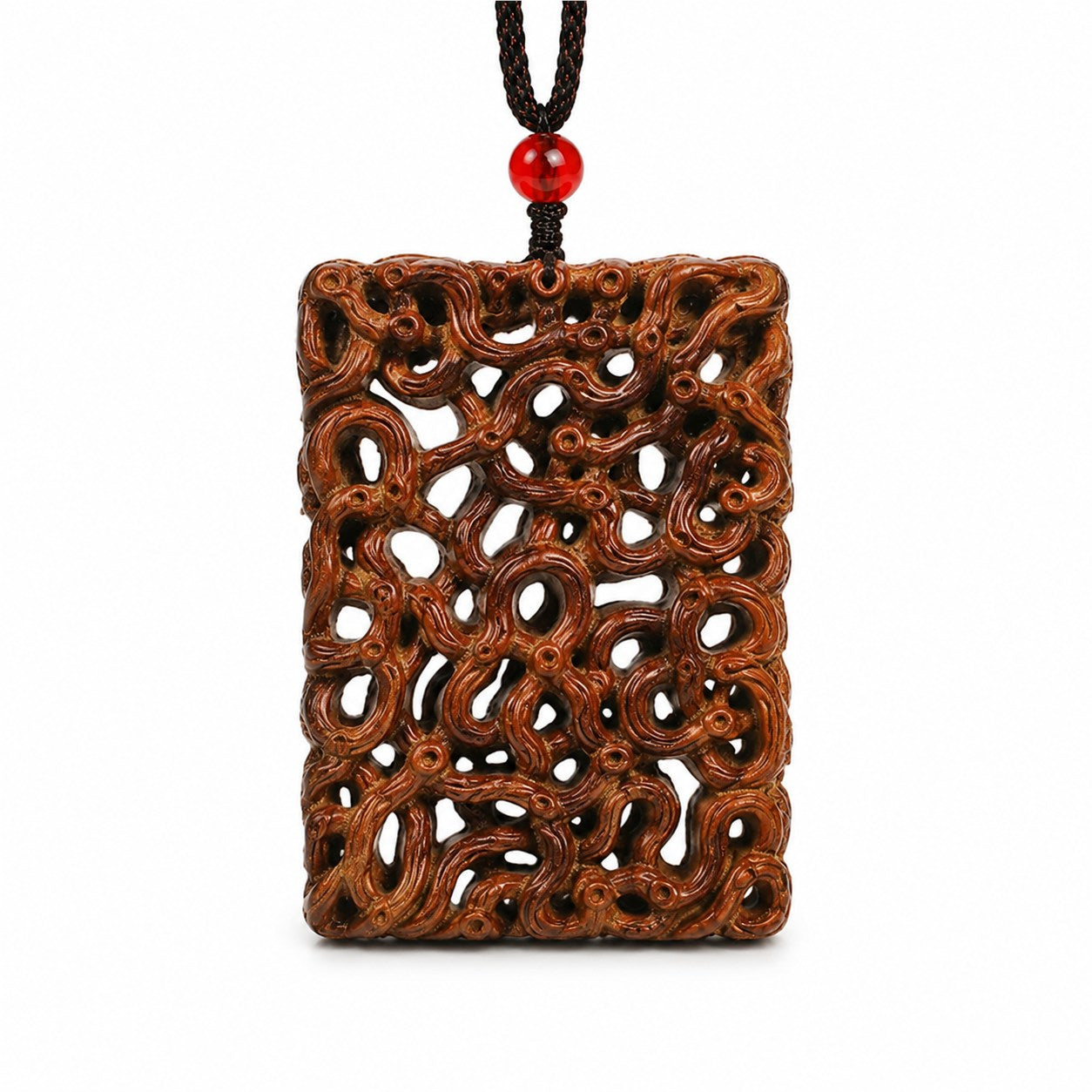 Front view of an openwork jujube wood dragon carving pendant with black braided cord