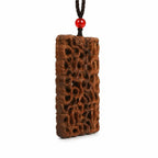 Side view showing the depth of an openwork jujube wood dragon carving pendant
