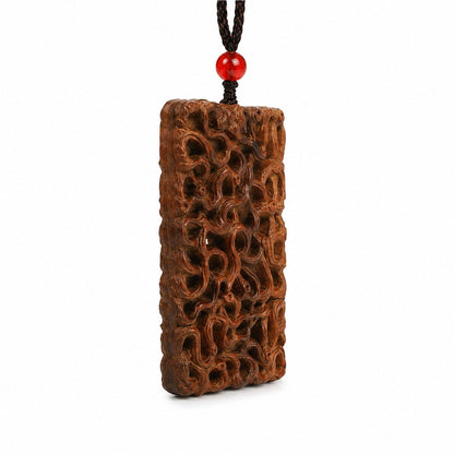 Side view showing the depth of an openwork jujube wood dragon carving pendant