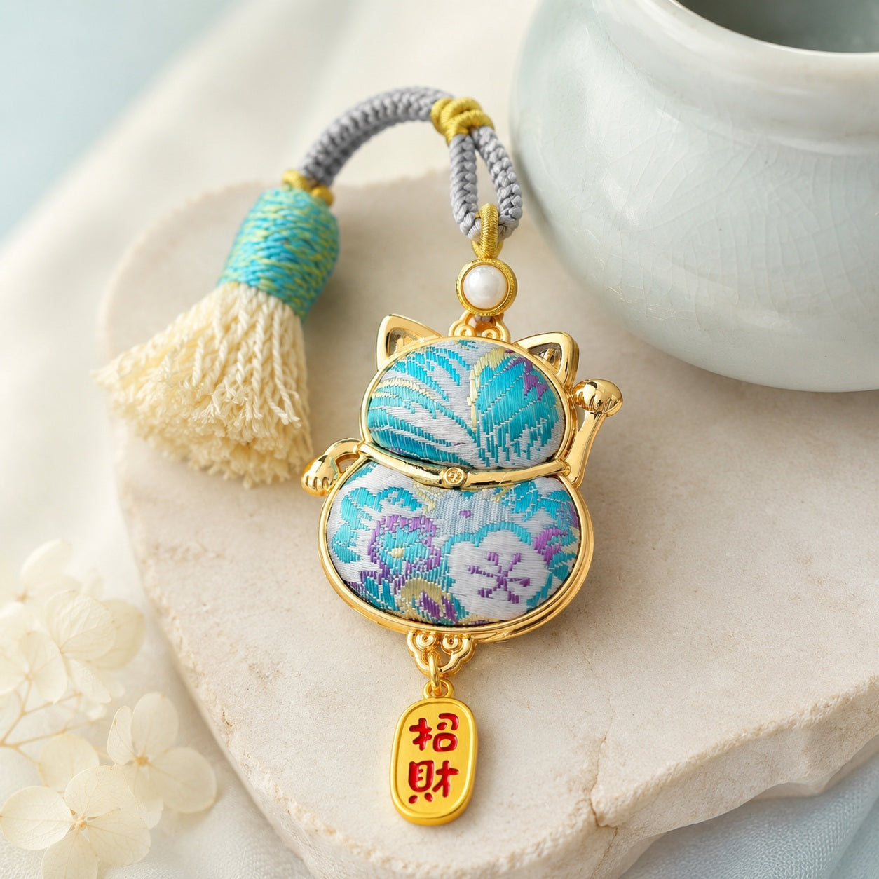 Lucky cat brocade tassel hanging charm in light blue with gold-tone trim and tassel