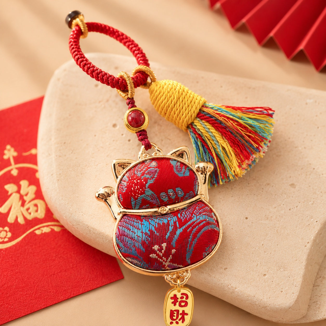 Lucky cat brocade tassel hanging charm in red with gold-tone trim and festive tassel