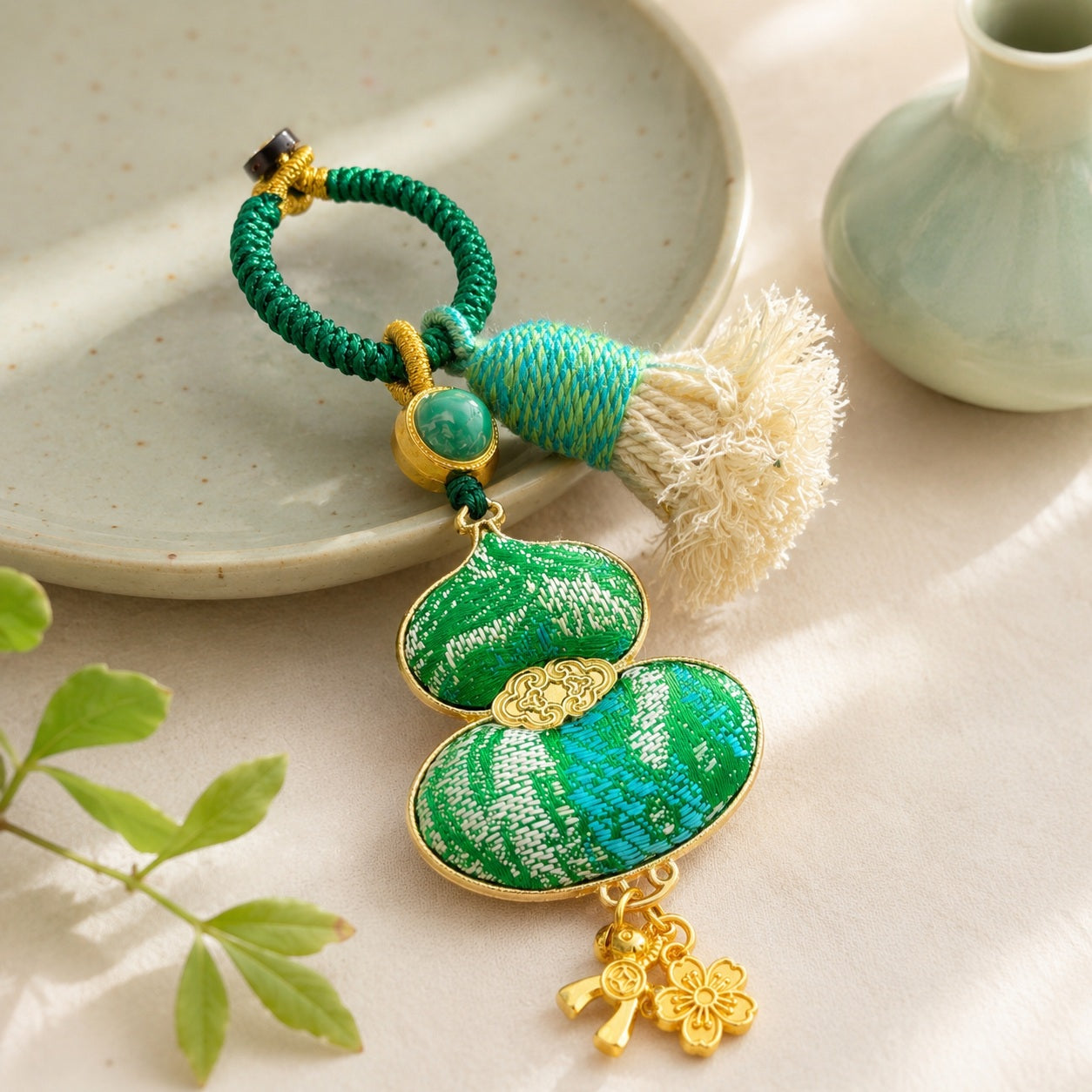 Green brocade lucky gourd hanging charm with decorative cotton tassel and lucky charms