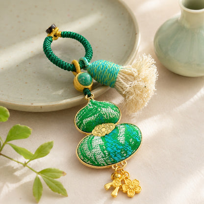 Green brocade lucky gourd hanging charm with decorative cotton tassel and lucky charms