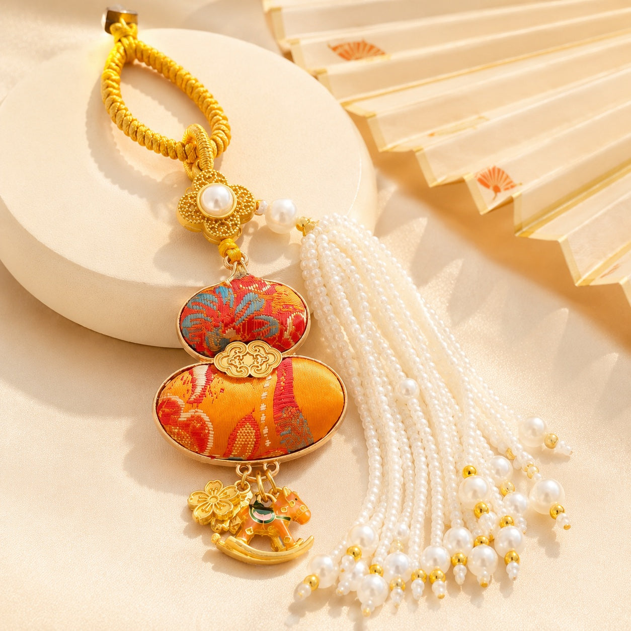 Orange brocade lucky gourd hanging charm with white pearl tassel and rocking horse charms