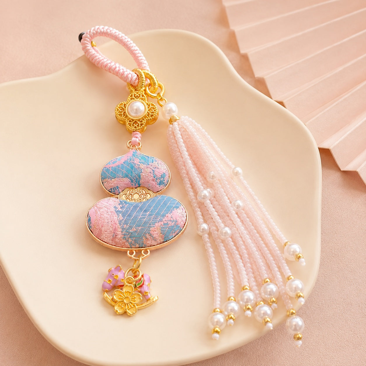 Pink and blue brocade lucky gourd hanging charm with pearl tassel and gold-tone details