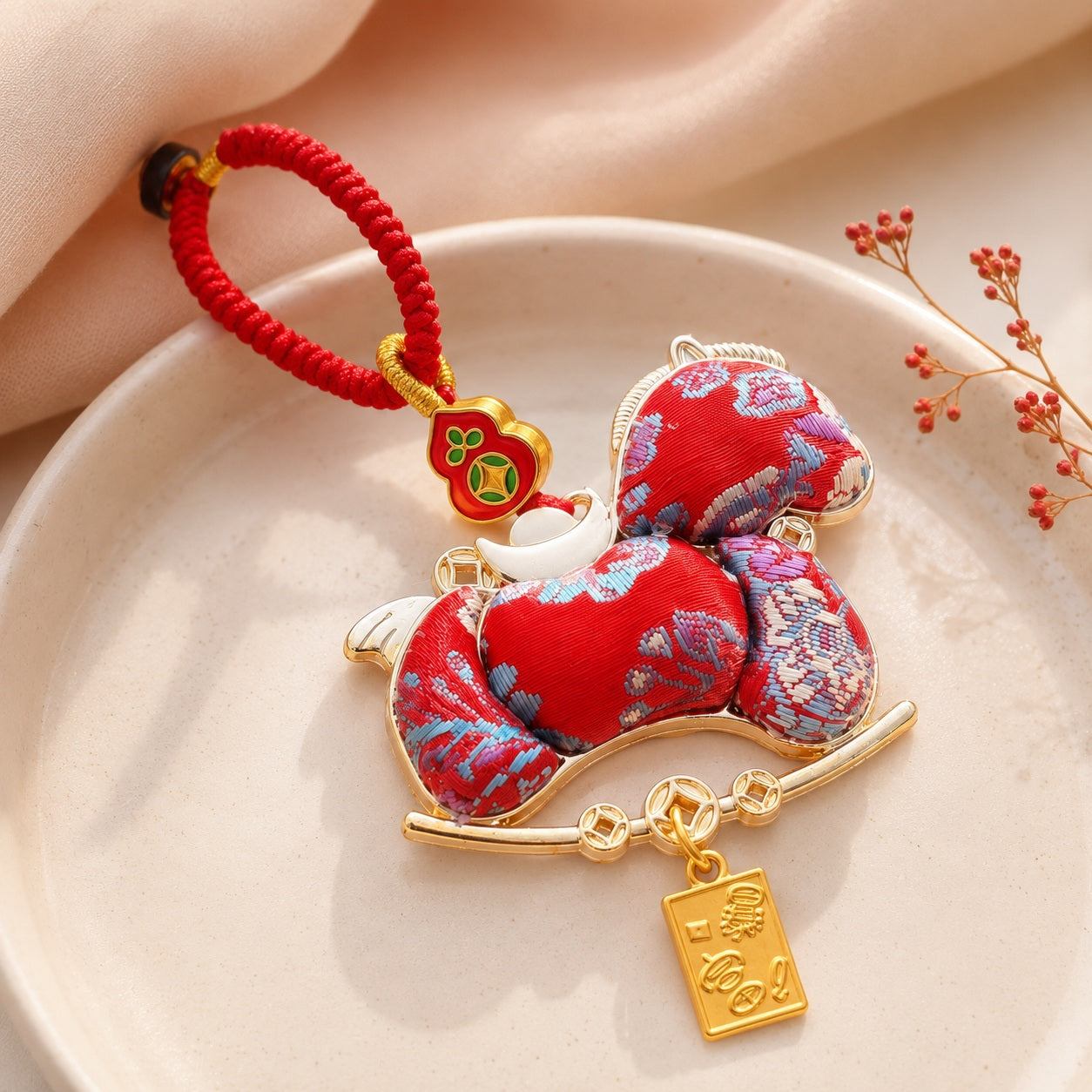 Red brocade lucky pony hanging charm with gold-tone fortune pendant