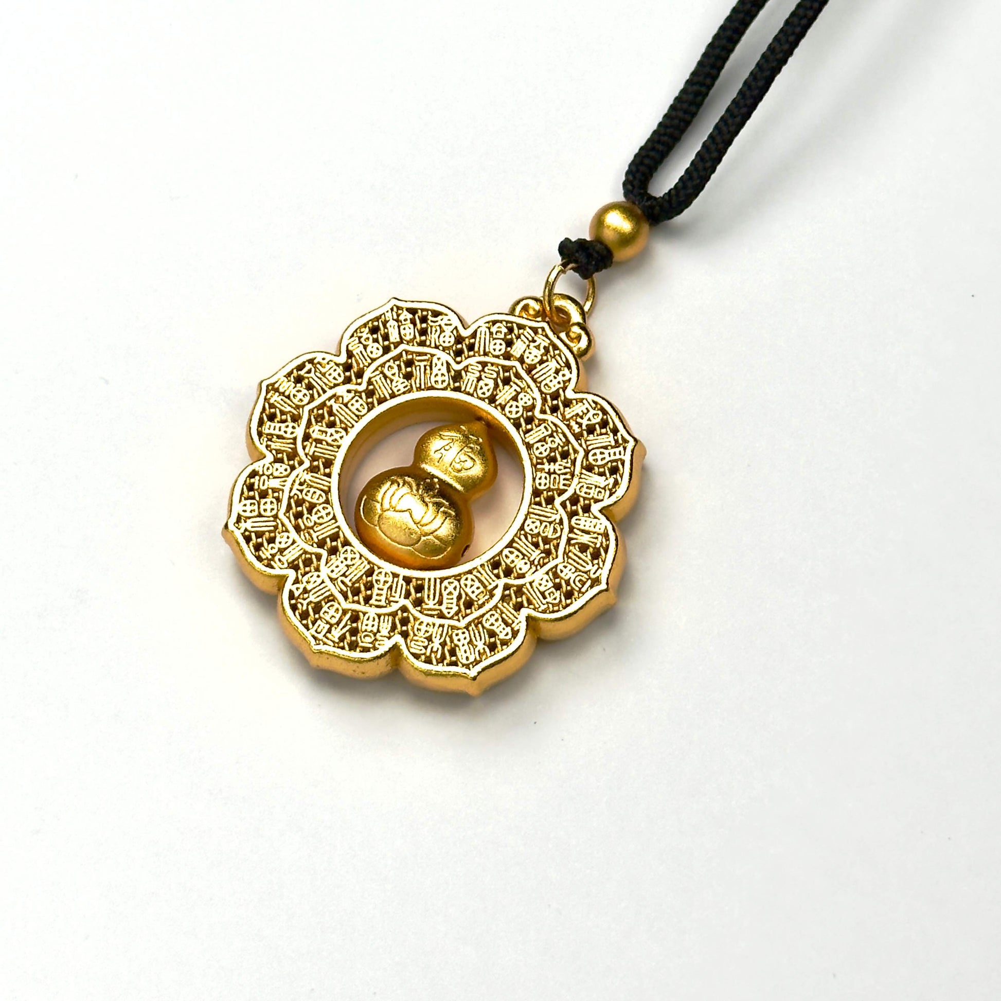 An angled studio view of a luxurious matte gold hundred-Fu blessings talisman, highlighting the precision Chinese calligraphy carving and smooth texture.
