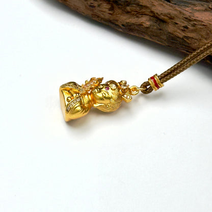 Macro close-up shot of an ancient style brushed sand gold Buddha deity charm resting against wood, capturing the precise rhinestone pavé rows.