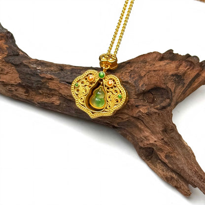 A luxurious sand gold Ruyi fortune amulet with a vibrant movable green stone gourd resting gracefully on a piece of rustic driftwood for a Zen aesthetic.