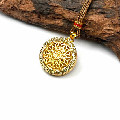 Macro close-up shot of an ancient style sand gold filigree Hulu charm on wood, capturing the precise metal openwork and luxurious 24K gold luster.