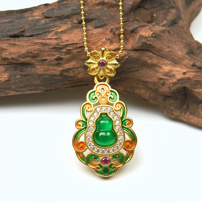 Macro close-up shot of a luxurious gold enamel Hulu charm on wood, capturing the beautiful translucent quality of the central green gemstone under natural light.