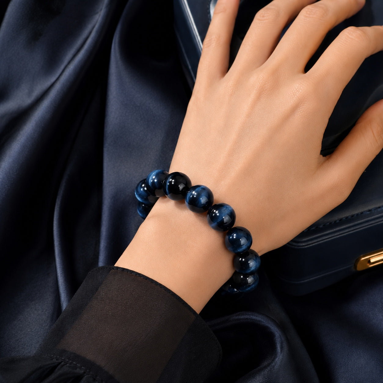 Close-up of blue tiger’s eye beaded bracelet worn on wrist