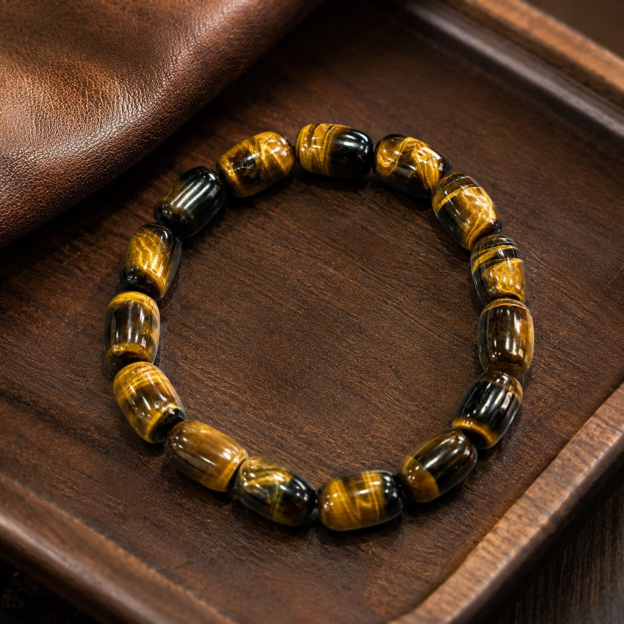 Midnight Glow tiger’s eye barrel bead bracelet on wooden tray