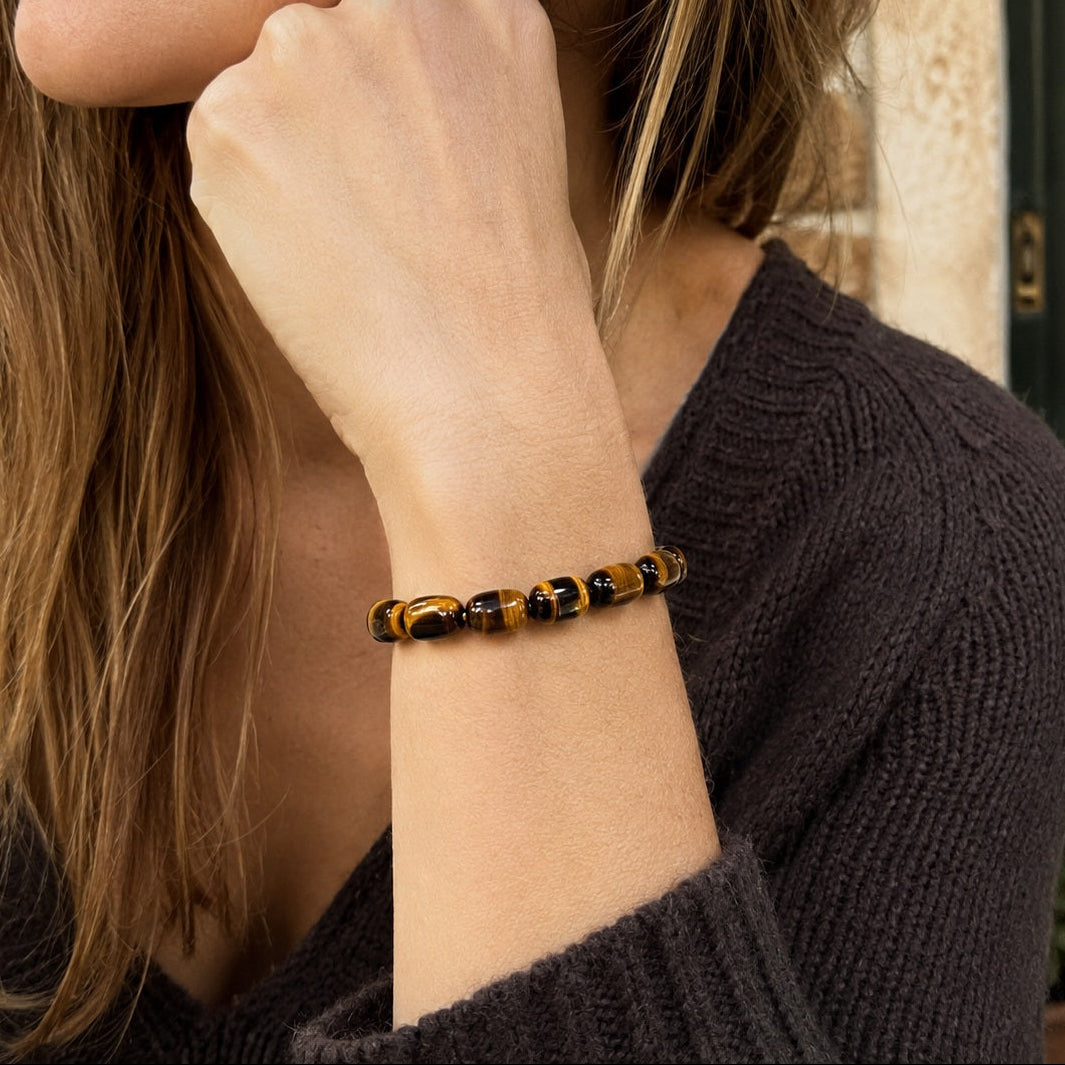 Woman wearing Midnight Glow tiger’s eye barrel bead bracelet