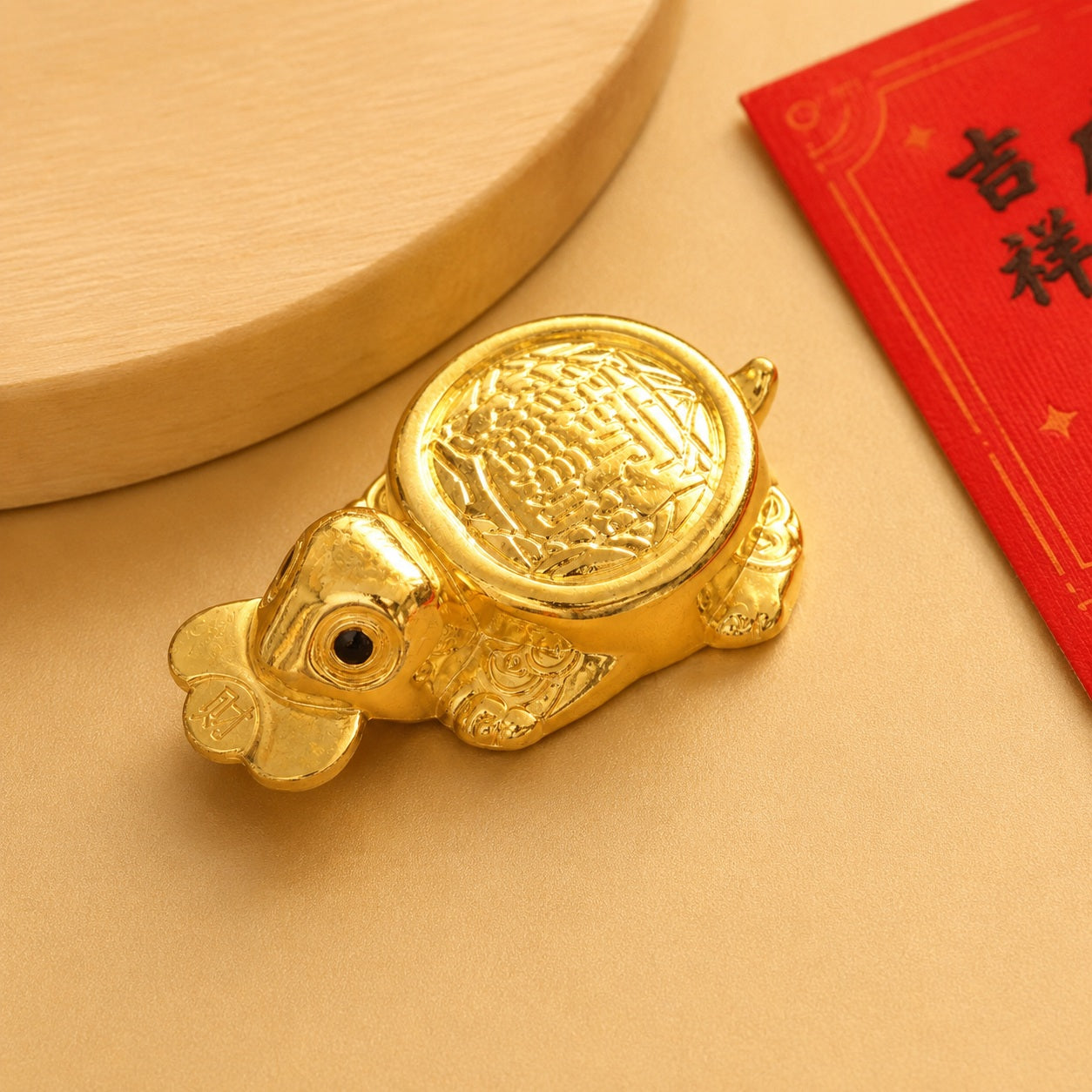 Money-Biting Turtle lucky Feng Shui decor beside a red Chinese greeting card