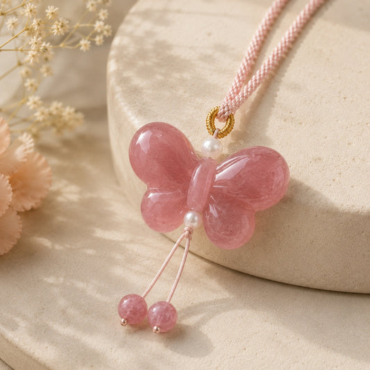 Butterfly pendant necklace made of pink quartzite jade on a soft neutral display