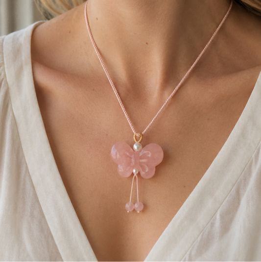 Woman wearing a pink butterfly quartzite jade pendant necklace
