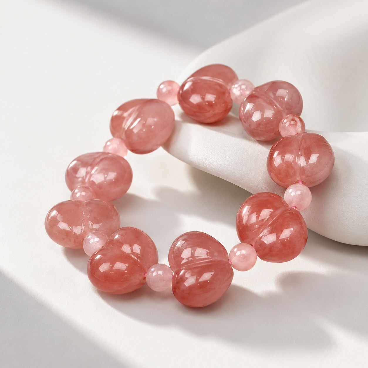 Quartzite jade heart bead bracelet with soft pink tones on a minimal display